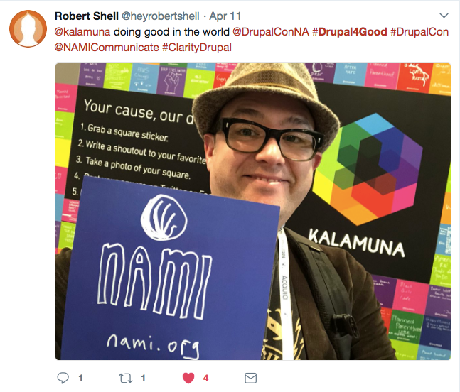 Robert holds up a sticker that reads NAMI.org