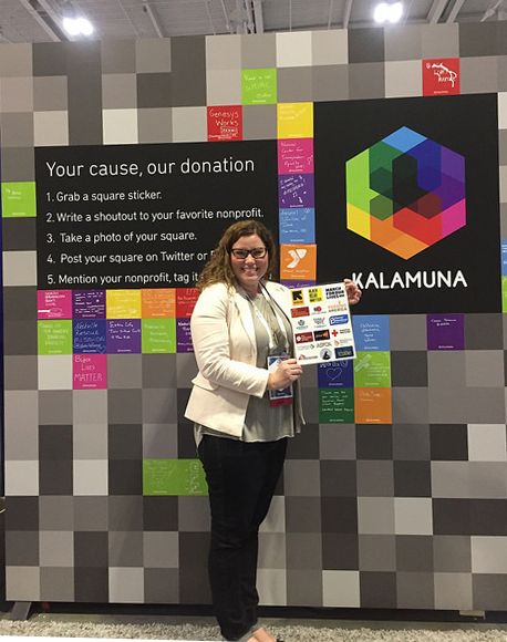 Kristin Sartain displays logos in front of the booth in progress