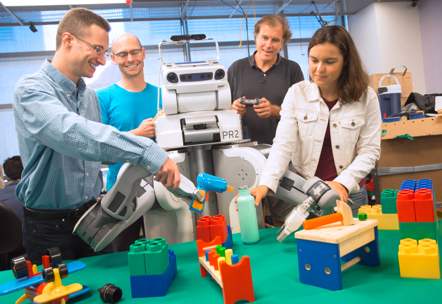 engineers and a robot using blocks