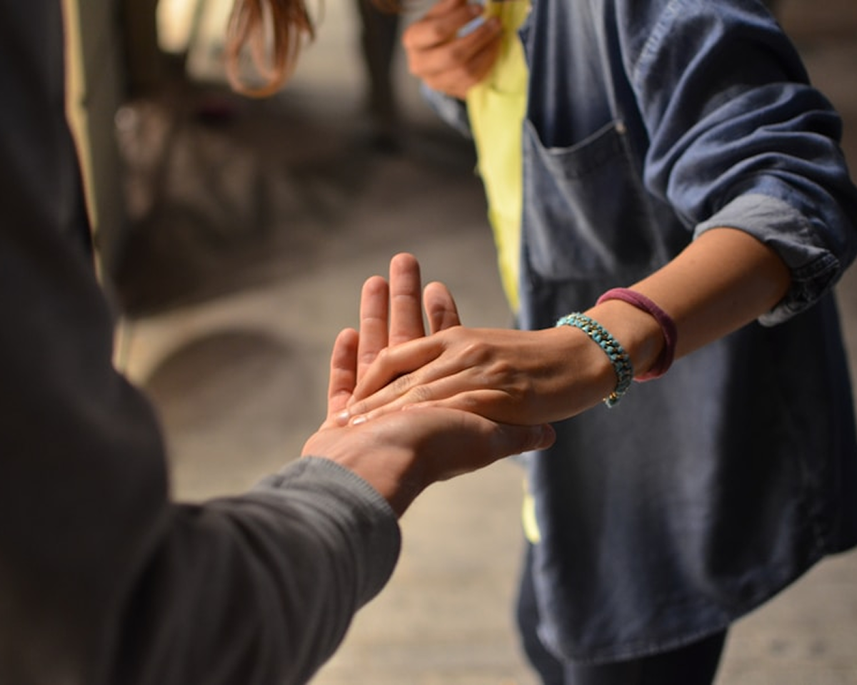 Two hands holding each other for support.