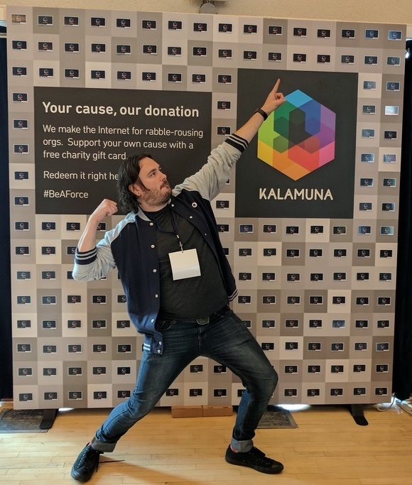 Josh poses in front of the Wall of Force at BADCamp 2017