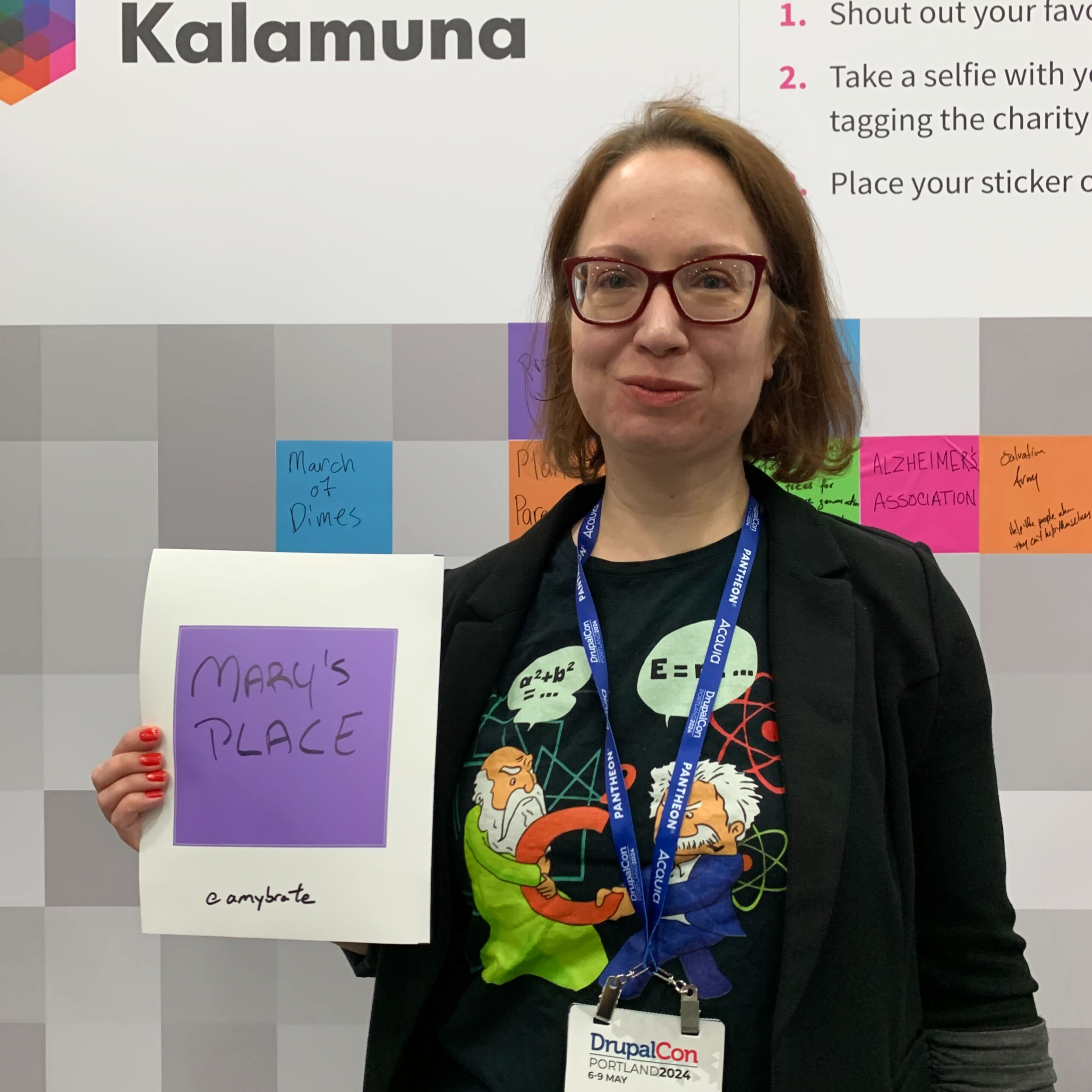 Amy Brate holds a purple square sticker with "Mary's Place" written on it.