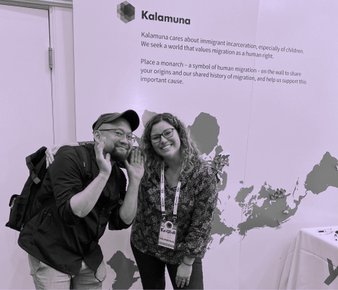 Two members of the Kalamuna team stand in front of their 2019 BADCamp booth