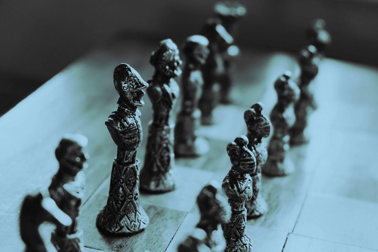 A chessboard with two rows of pieces lined up waiting to move 