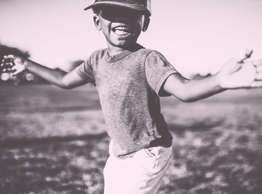 A smiling boy playing outside
