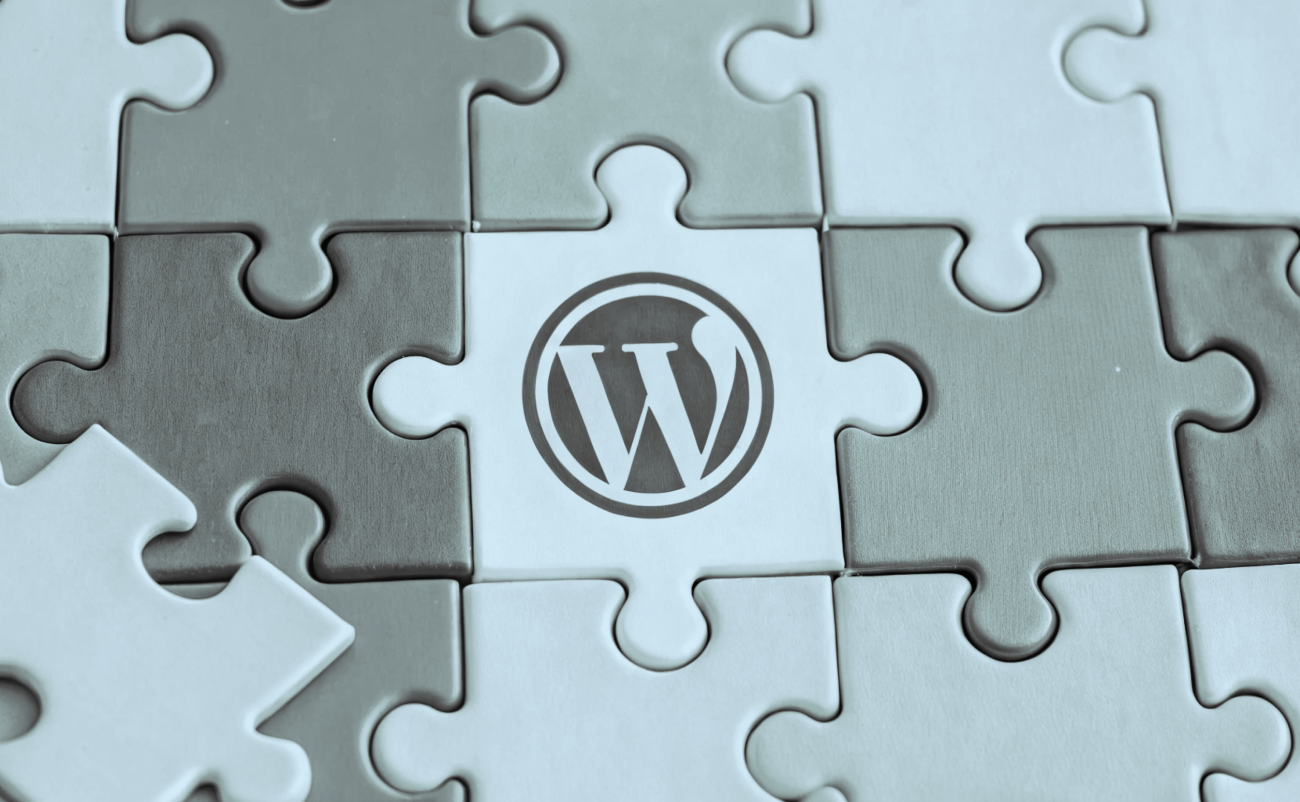 Nine puzzle pieces put together, with the WordPress logo on the center piece.